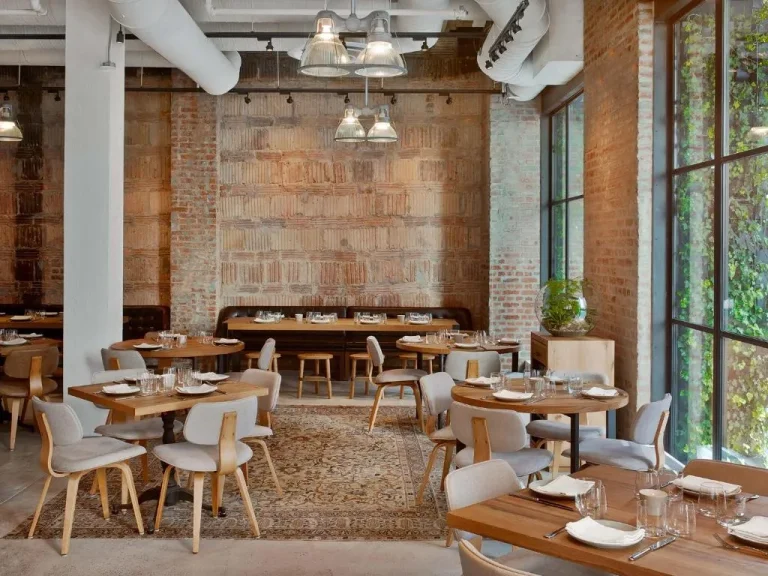 Dining area with wooden tables at 1 Hotel Central Park