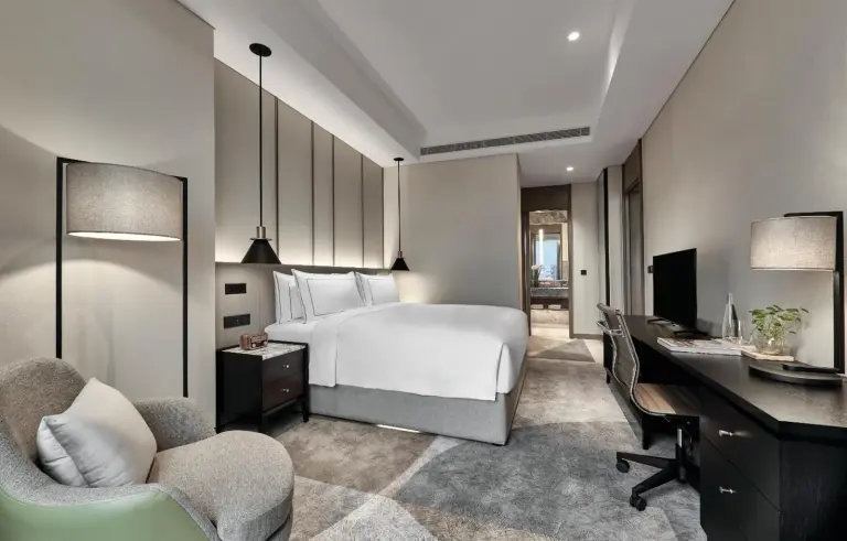 a hotel room with a bed and a desk at 25hours Hotel Jakarta The Oddbird in Jakarta