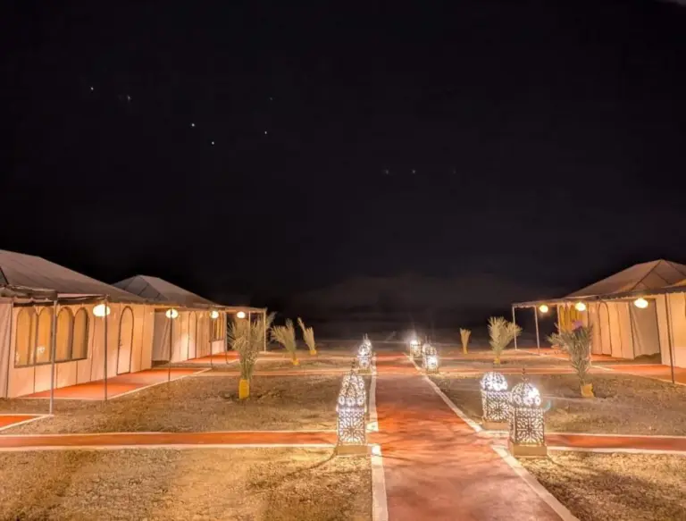 Achabou Desert Camp illuminated at night