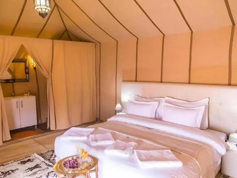 Luxurious tent bedroom at Africa Stars Camp in Merzouga.