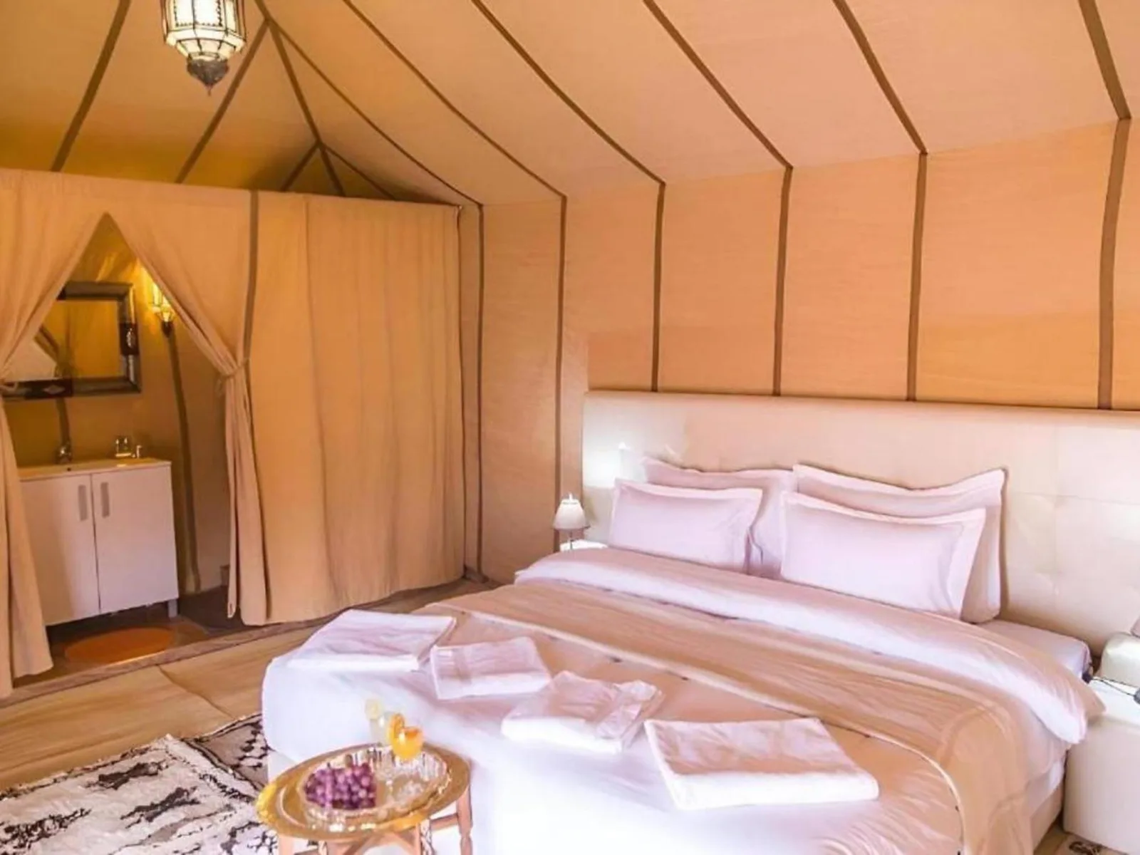 Luxurious tent bedroom at Africa Stars Camp in Merzouga.