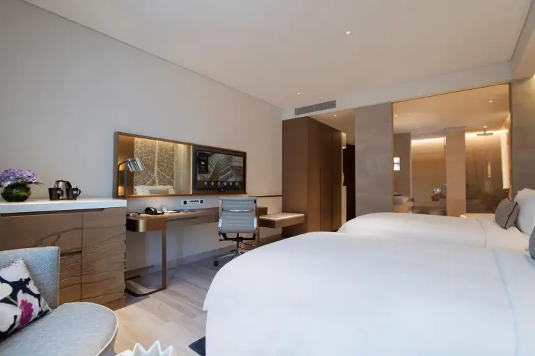 Guest room with work desk and TV at Al Bandar Rotana – Dubai Creek in Dubai