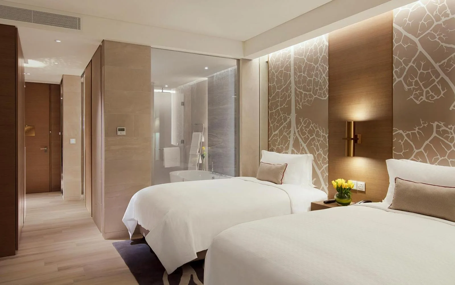 Twin bed room at Al Bandar Rotana – Dubai Creek in Dubai with modern interior and bathroom access