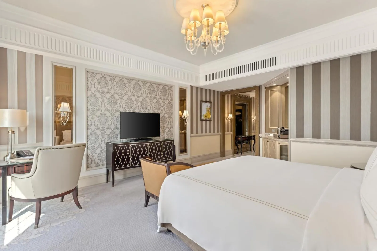 Al Habtoor Palace - Preferred Hotels & Resorts – hôtel à Dubaï, Émirats arabes unis – une chambre avec un grand lit et un salon à Al Habtoor Palace - Preferred Hotels & Resorts à Dubaï
