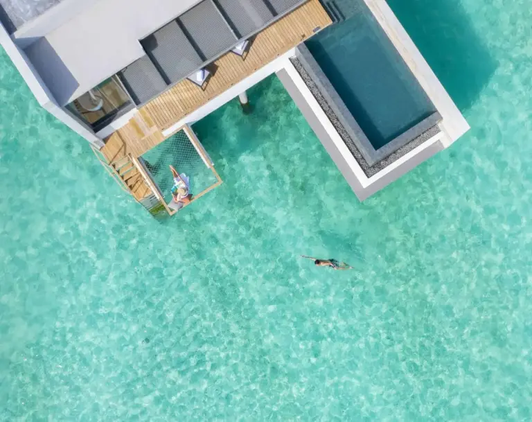Guests relaxing in water at Alila Kothaifaru Maldives