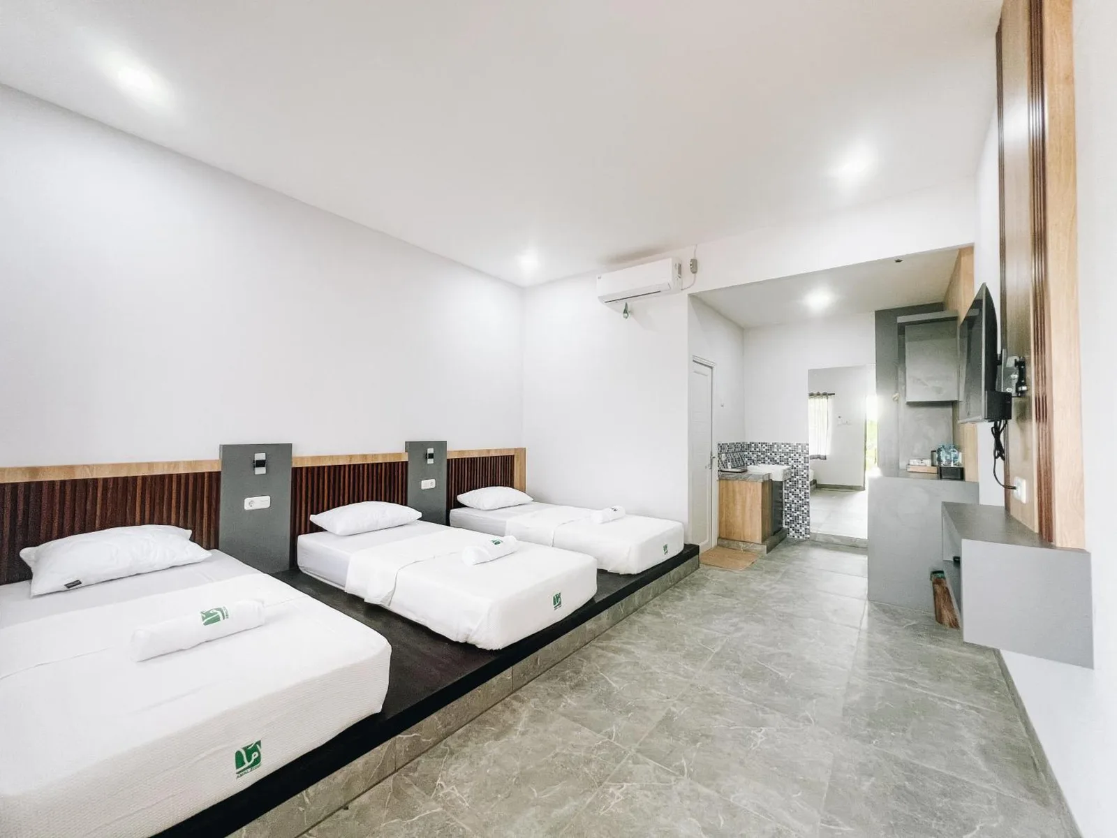 Dormitory-style room at Amal Zone Villa in Pontianak with multiple single beds and a modern shared layout.