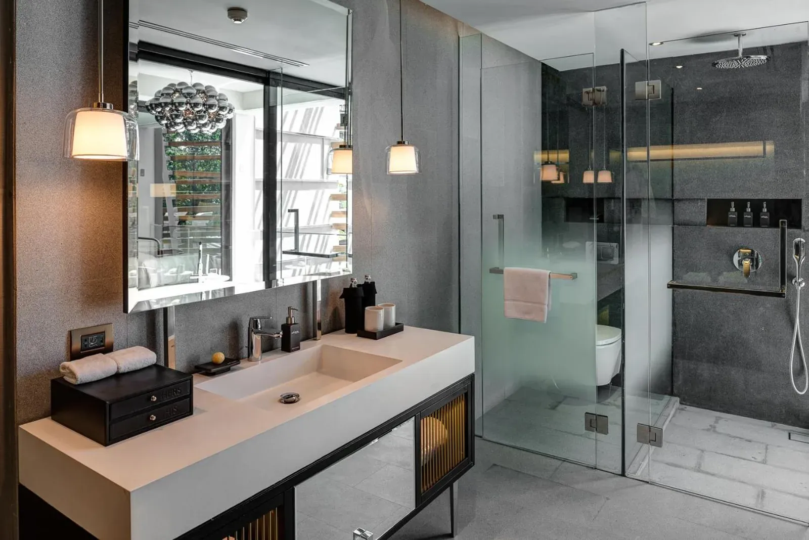 Sleek bathroom with glass shower at AMANOR Hotel Chiang Mai