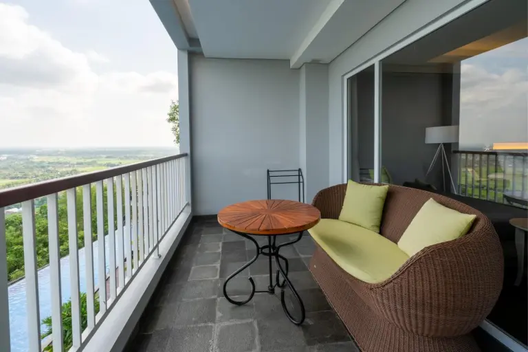 Balcony seating area at Amaranta Prambanan Yogyakarta overlooking the scenic landscape.