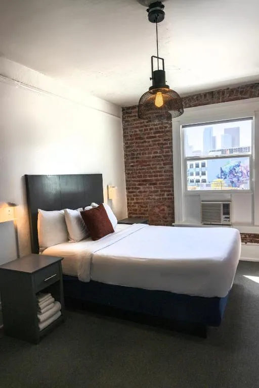 American Hotel cozy bedroom with brick walls