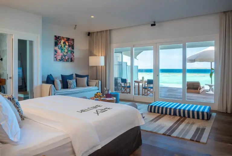 Elegant room interior at Amilla Maldives with terrace access