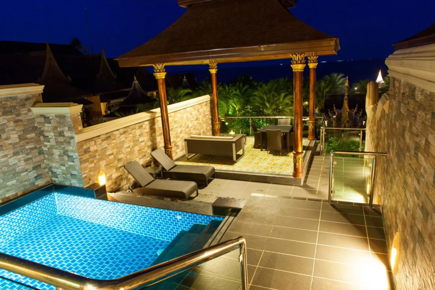 Night view of the pool area at Ammatara Pura Pool Villa in Koh Samui
