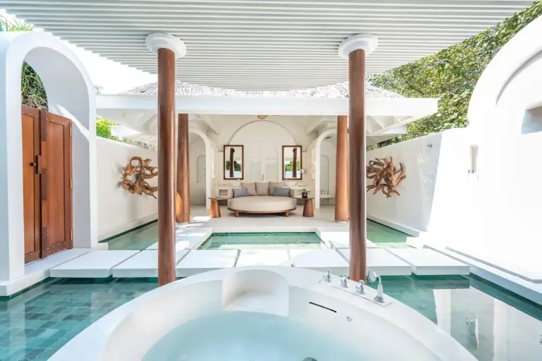 Outdoor jacuzzi area at Anantara Kihavah Maldives Villas with lush privacy.
