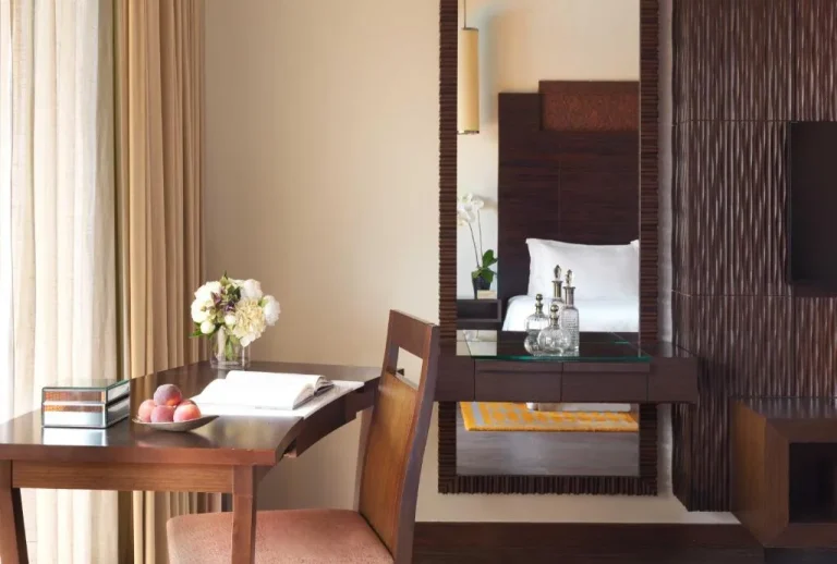 Desk space in room at Anantara The Palm Dubai Resort decorated with flowers.