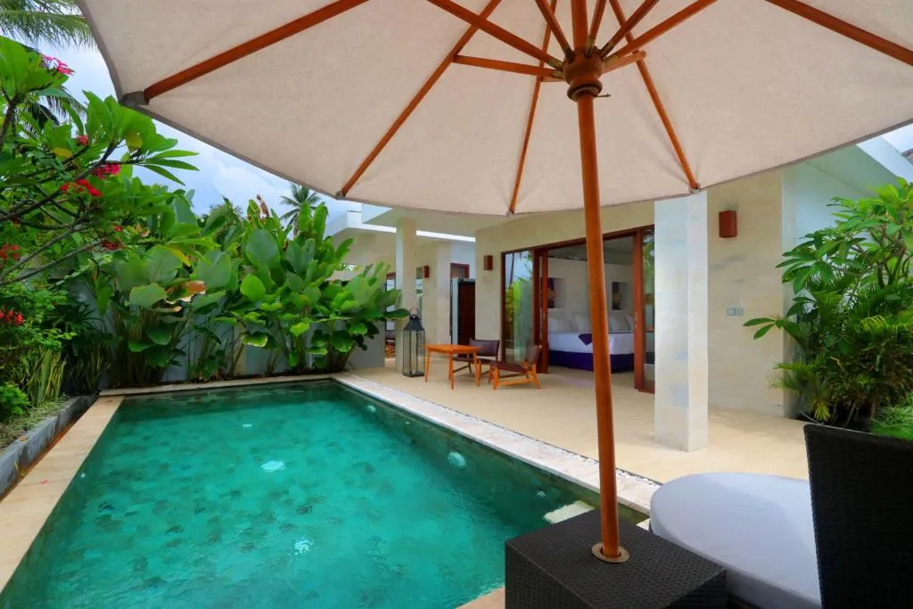 Lounge area by the pool of a villa at Anema Wellness & Resort Gili Lombok