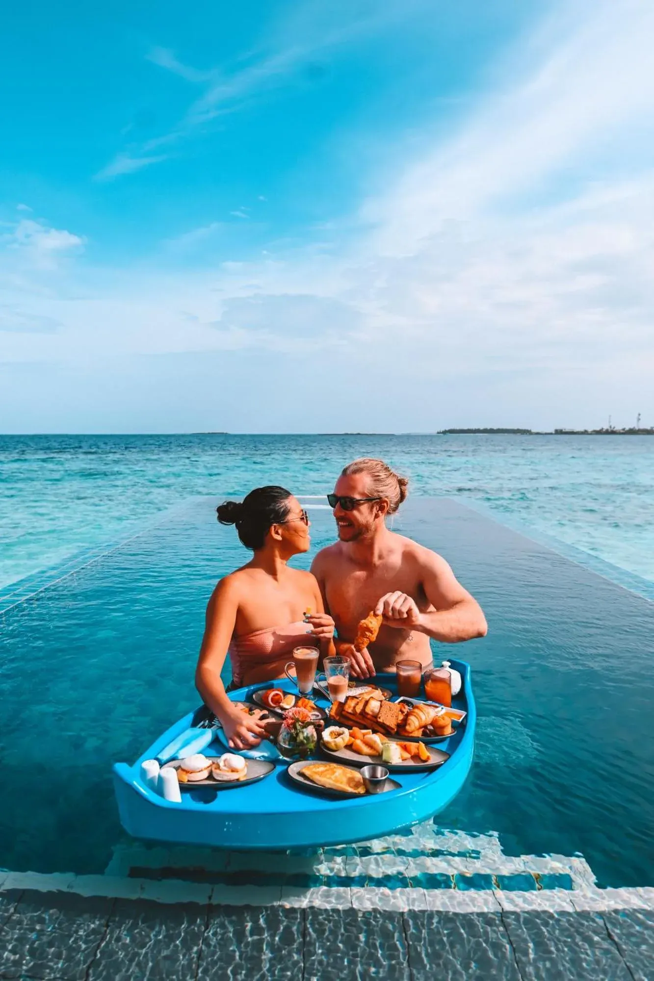 Couple dining in pool at Angsana Velavaru