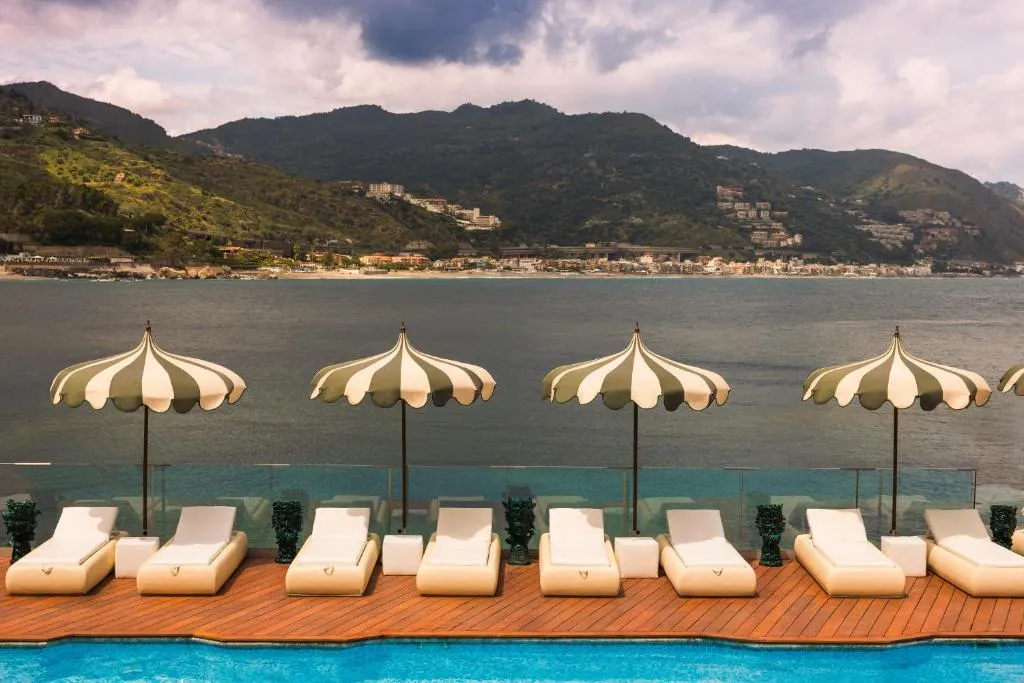 Atlantis Bay hotel pool area with loungers and umbrellas overlooking the sea