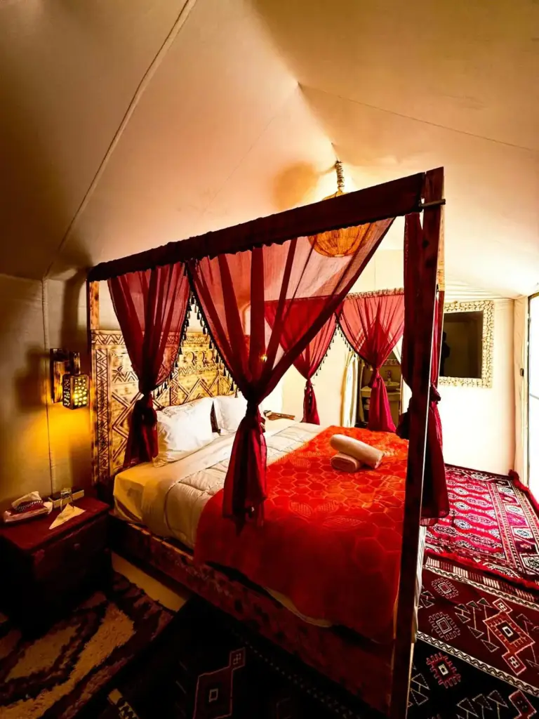 Four-poster bed in room at Authentic Luxury Camp, Merzouga