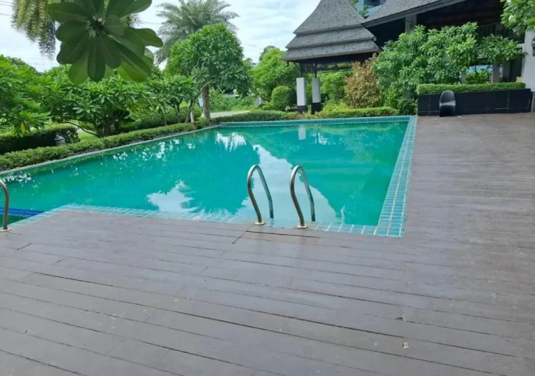 Swimming pool at Baan Bangsaray Hotel surrounded by greenery