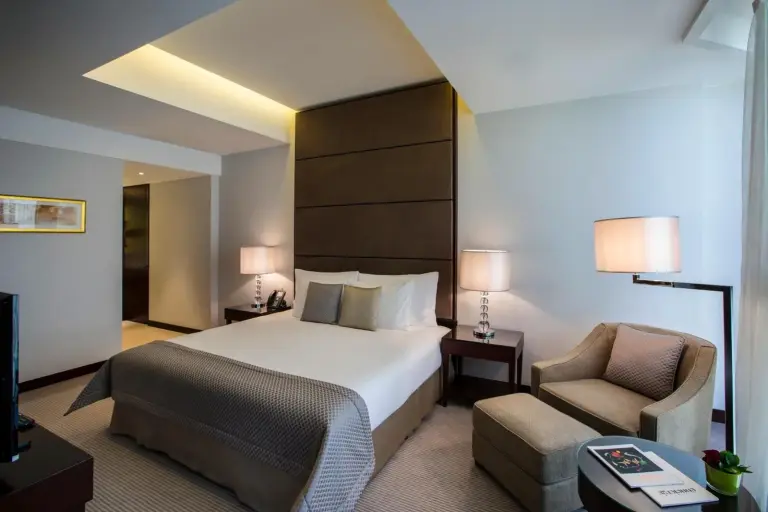 a hotel room with a bed and a chair at Bab Al Qasr Residence in Abu Dhabi