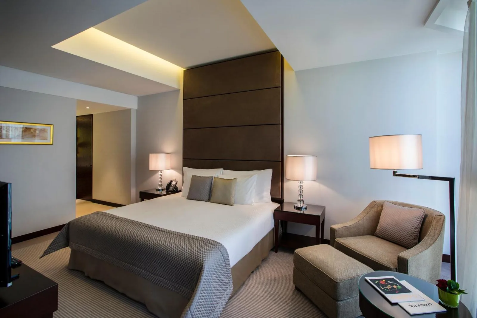 a hotel room with a bed and a chair at Bab Al Qasr Residence in Abu Dhabi