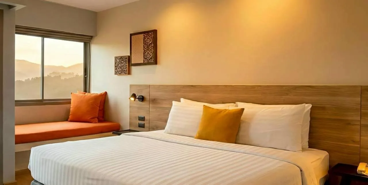 Deluxe guest room at Beehive Boutique Hotel Phuket in Phuket with window seat and mountain view
