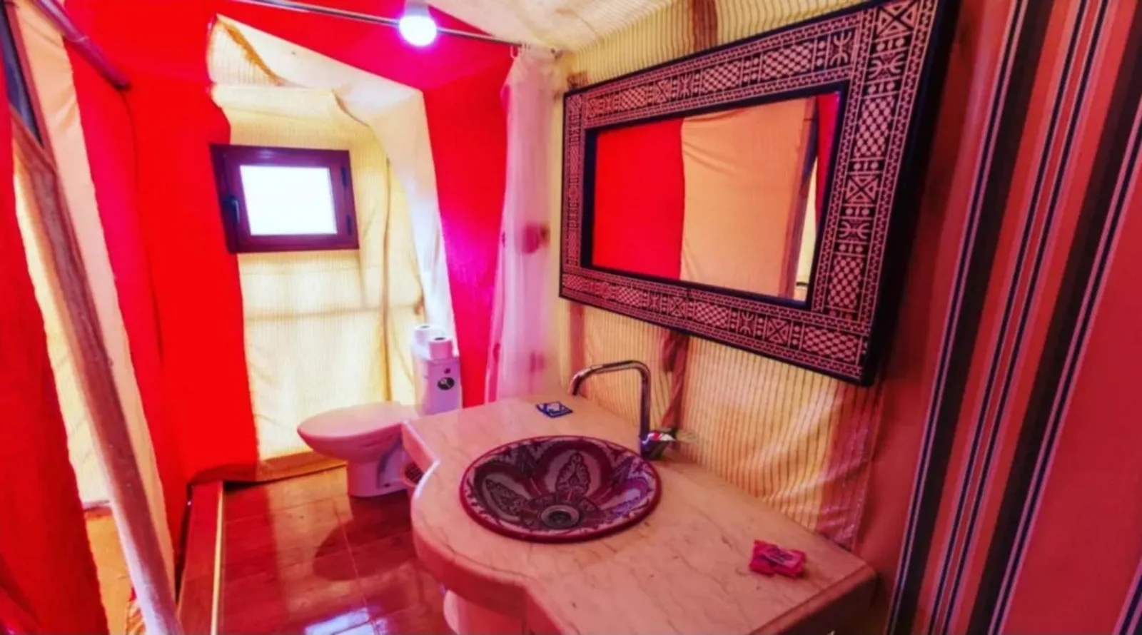 Best Classic Sahara Experiences in Merzouga tent bathroom with sink, mirror, and private shower