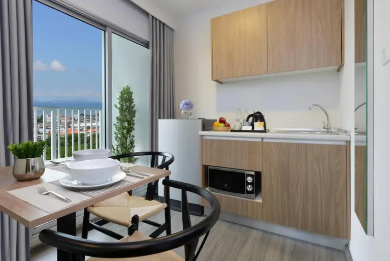 Kitchenette and dining area at Centre Point Prime Hotel Pattaya with balcony views