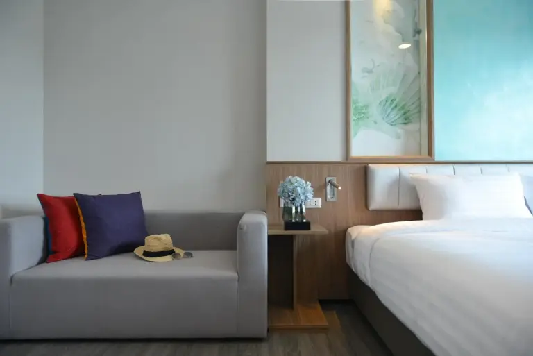 Living area at Centre Point Prime Hotel Pattaya with sofa and bedroom view