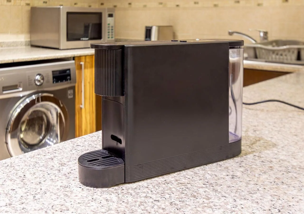 Coffee machine and kitchenette counter inside City Premiere Hotel Apartments Dubai.
