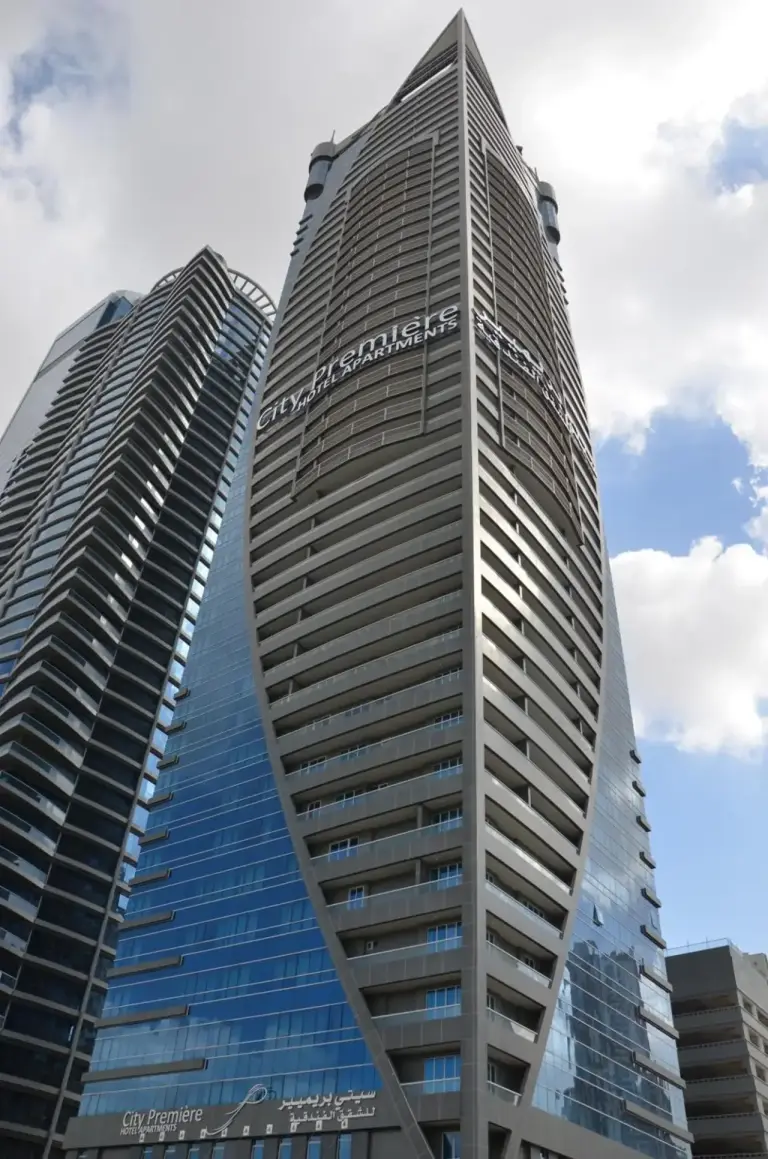 Exterior view of City Premiere Hotel Apartments in Dubai, showing the modern high-rise tower against the sky.