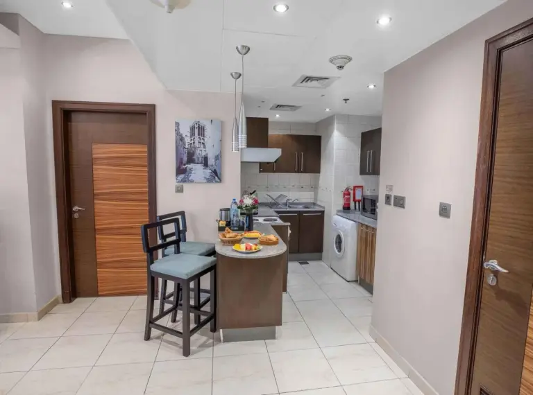 Kitchen area inside City Premiere Hotel Apartments Dubai with dining counter, cabinets, and compact appliances.