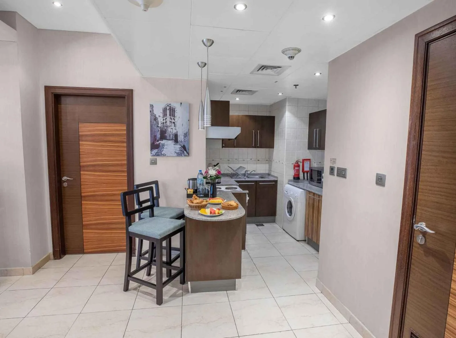 Kitchen area inside City Premiere Hotel Apartments Dubai with dining counter, cabinets, and compact appliances.