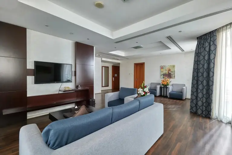City Premiere Marina Hotel Apartments living area with TV