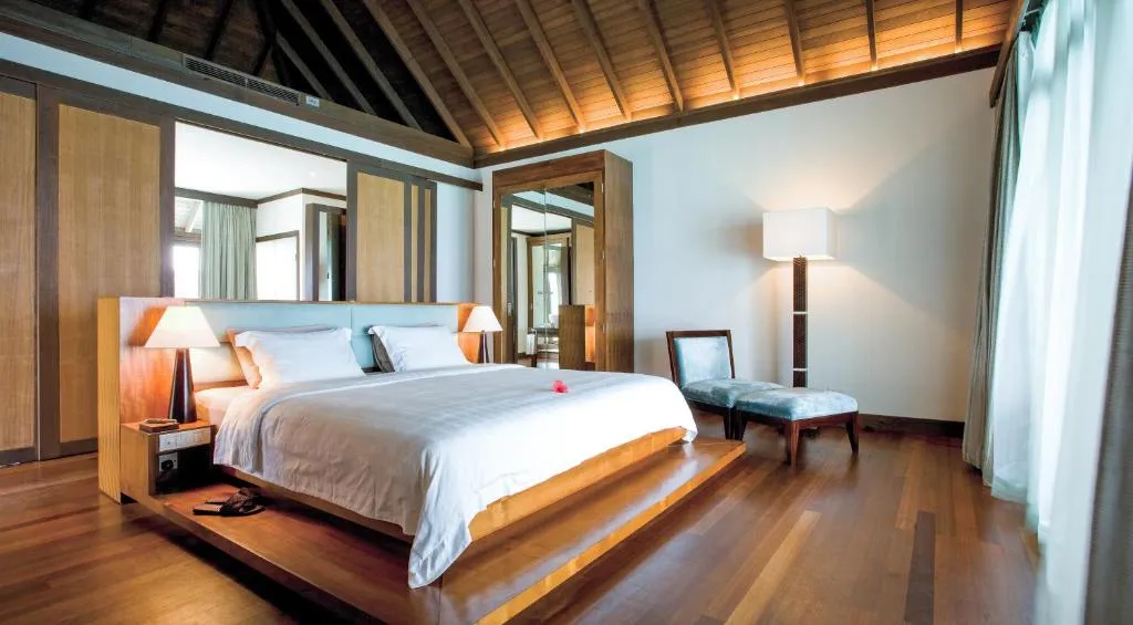 Sophisticated bedroom in a villa at Coco Bodu Hithi, featuring modern furnishings and serene decor.