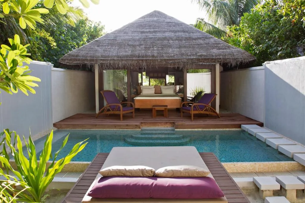 Beautiful poolside villa at Coco Bodu Hithi, designed for relaxation under the sun.