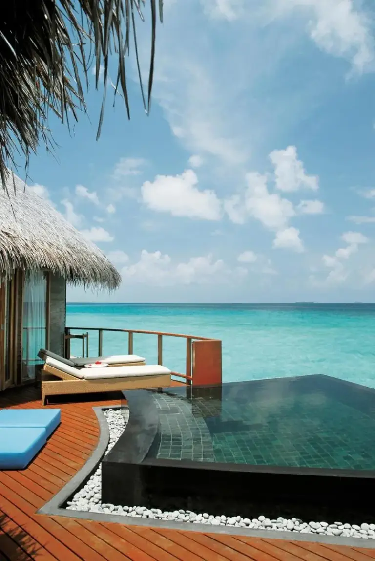 Poolside view from a water villa at Constance Halaveli, Maldives