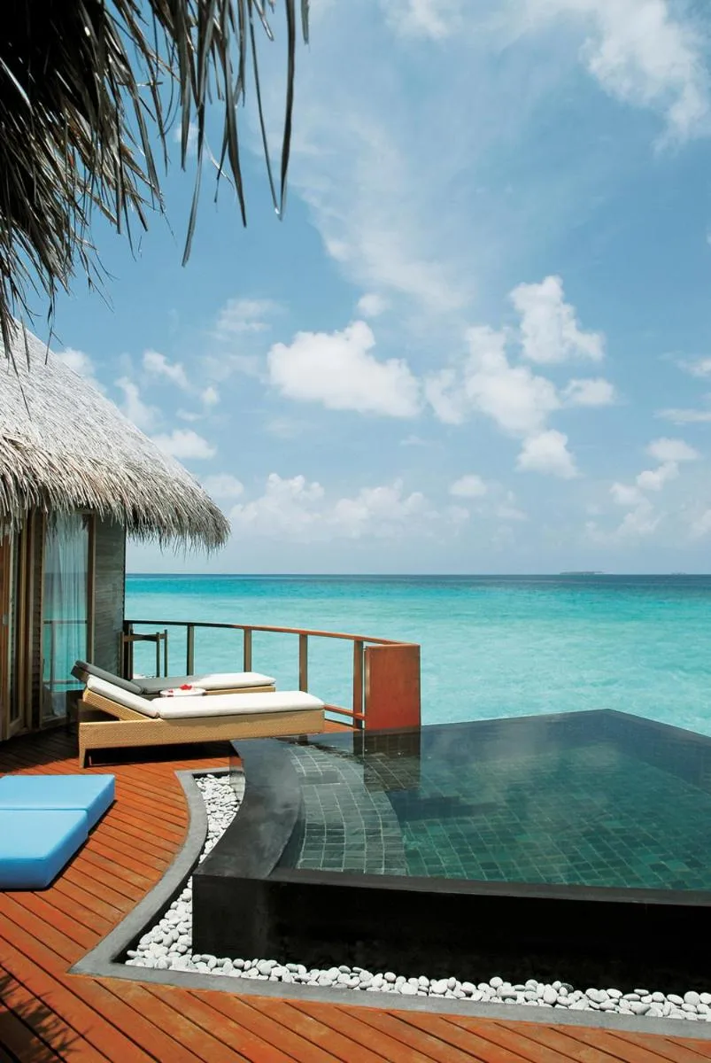 Poolside view from a water villa at Constance Halaveli, Maldives