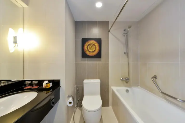 Bathroom at D Varee Jomtien Beach, Pattaya with bathtub, toilet, and vanity sink.