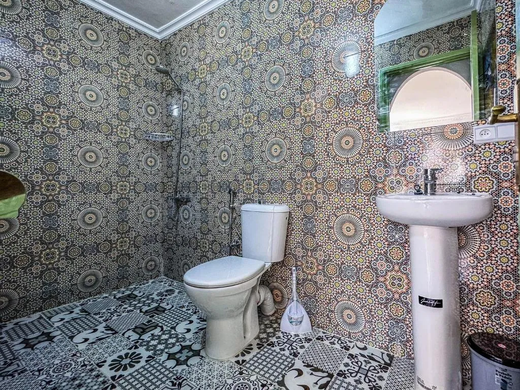 Stylish bathroom at Dar Sharif Tanger with patterned tiles