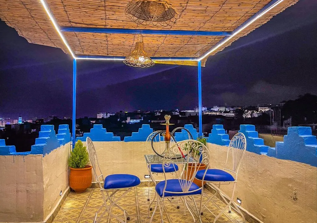 Nighttime rooftop view at Dar Sharif Tanger with city lights