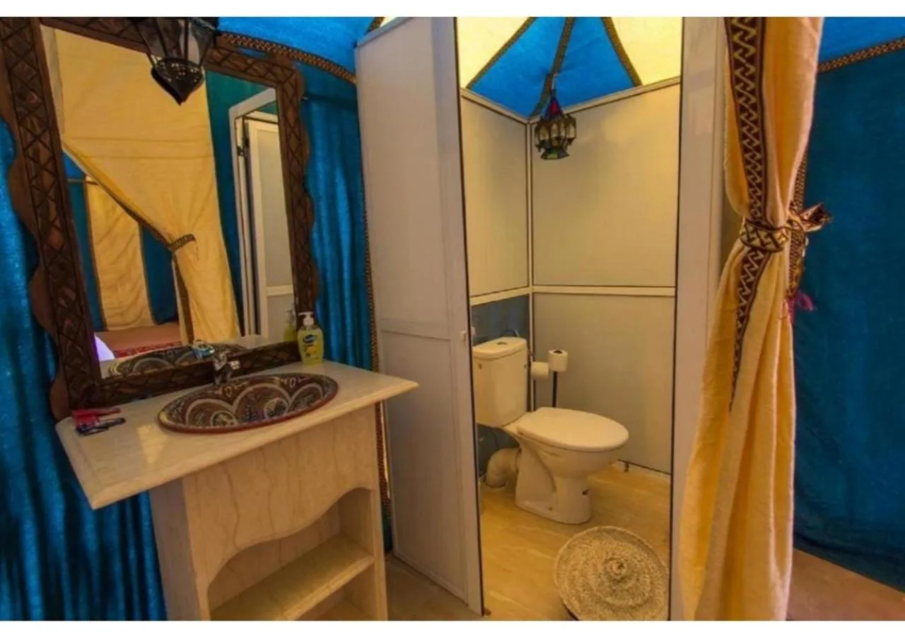 Desert Berber Luxury Camp in Merzouga tent bathroom with sink toilet and shower area