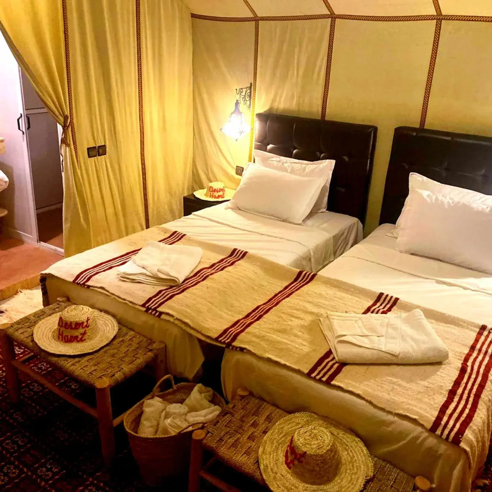 Interior of a comfortable twin bed tent at Desert Heart Luxury Camp