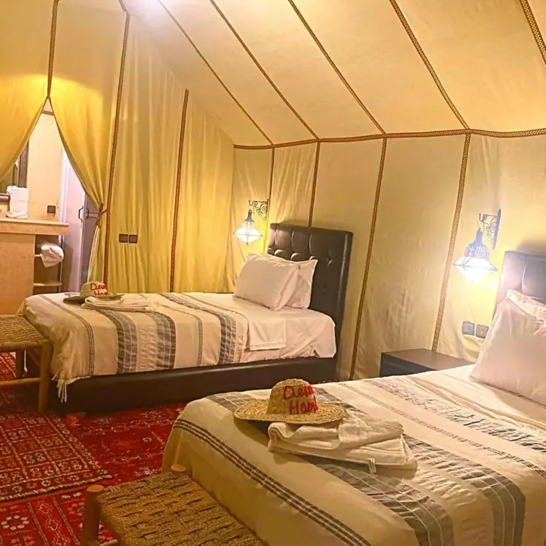 Spacious tent with beds at Desert Heart Luxury Camp