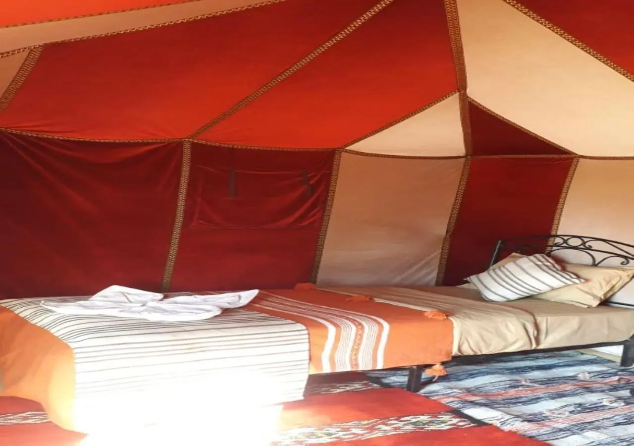 Simple bedroom setup at Desert Life Camp in Merzouga