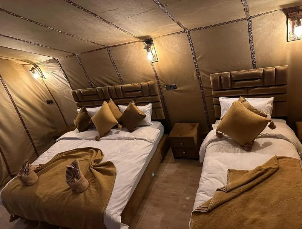 Double bed in guest room at Desert Nights Camp