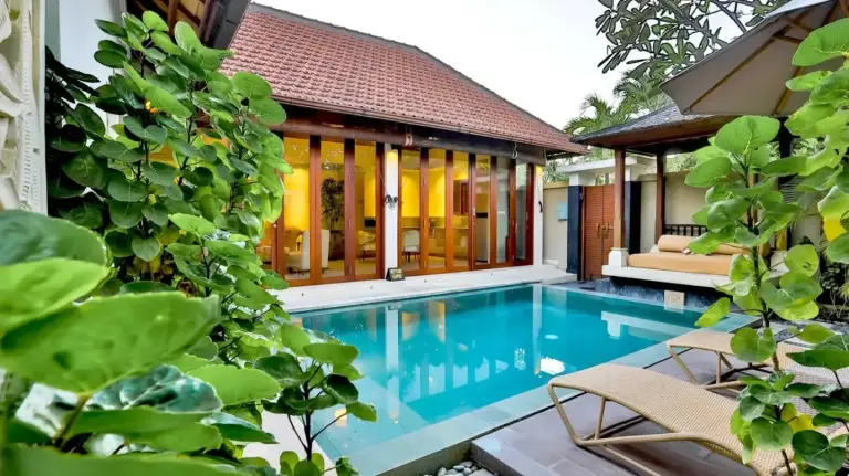 Daytime private pool villa at DISINI Luxury Spa Villas-CHSE Certified in Seminyak surrounded by tropical greenery and lounge seating