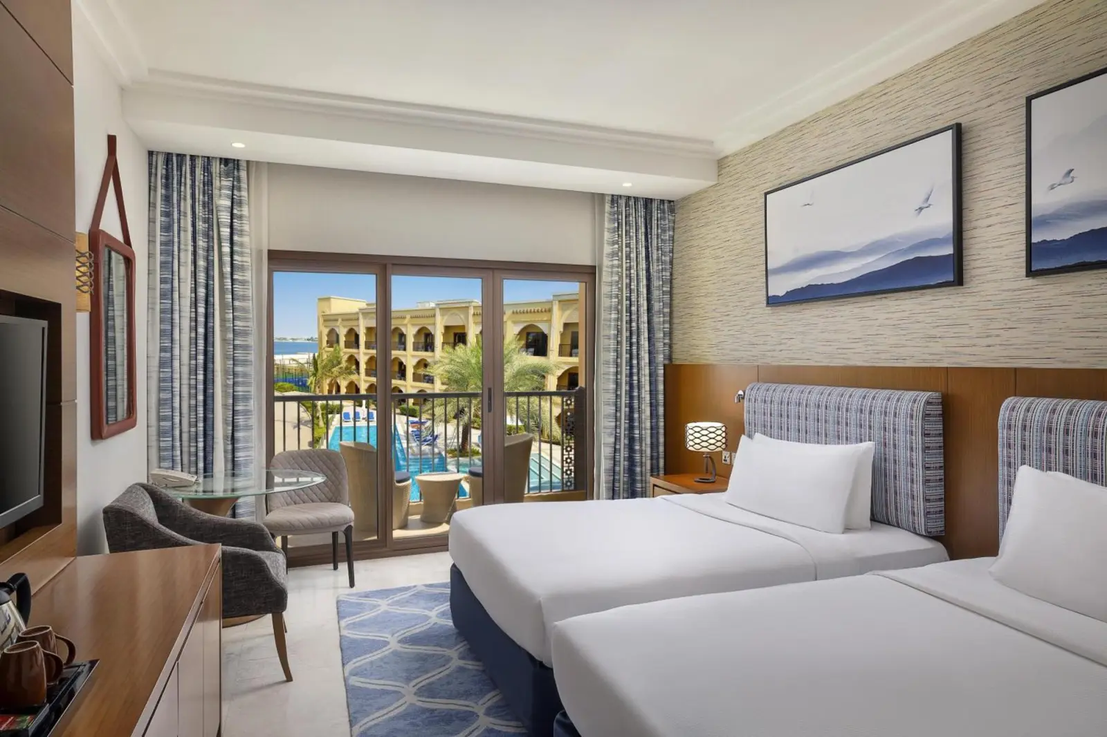 Guest room overlooking pool at DoubleTree by Hilton Resort & Spa Marjan Island