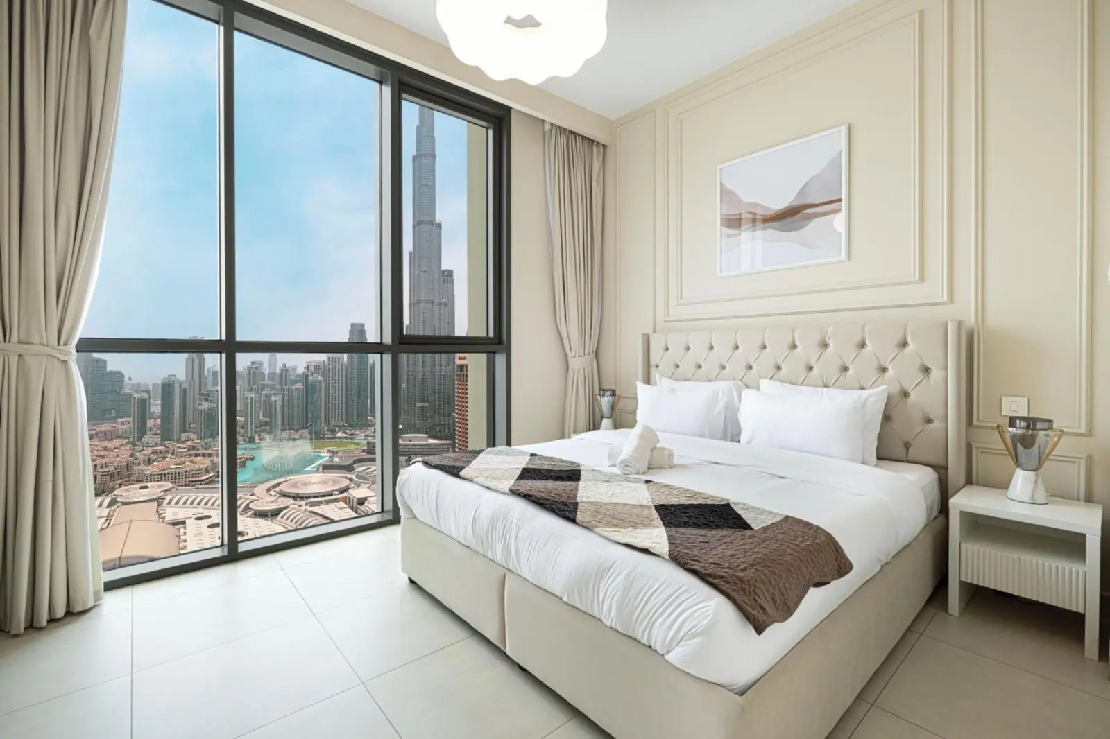 Modern hotel bedroom featuring Burj Khalifa view at Downtown Dubai.