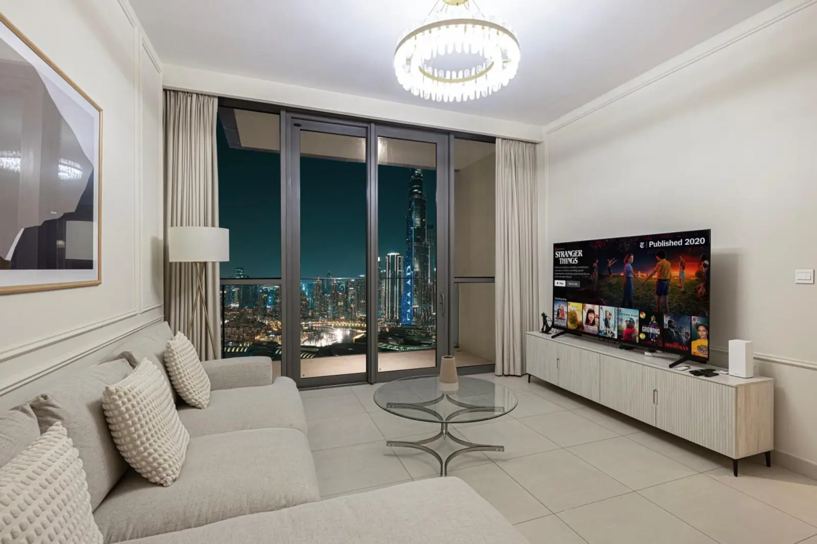 Chic hotel living room with night view of Dubai skyline, Downtown Dubai.