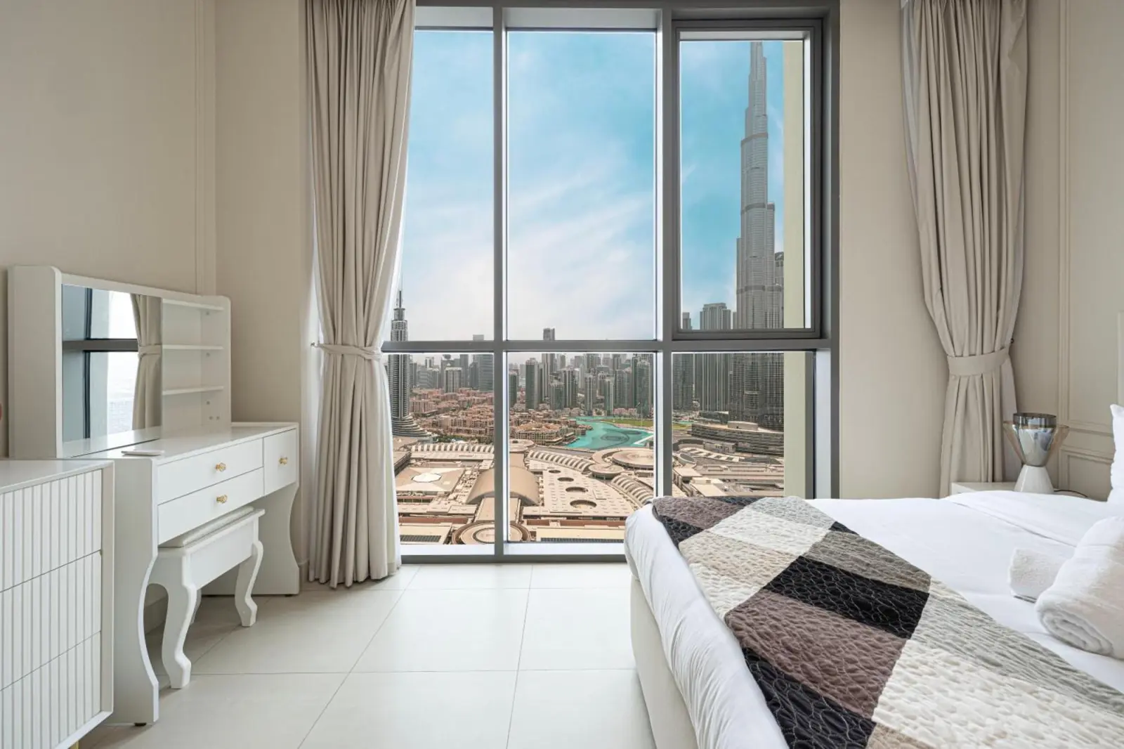Inviting hotel room with panoramic view of Burj Khalifa, Downtown Dubai.